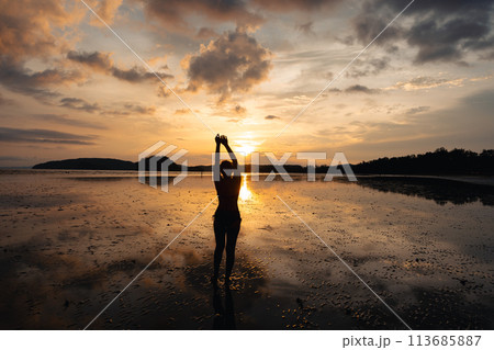 summer travel,Woman walking on the beach in the evening summer travel,Woman walking on the beach in the evening 113685887