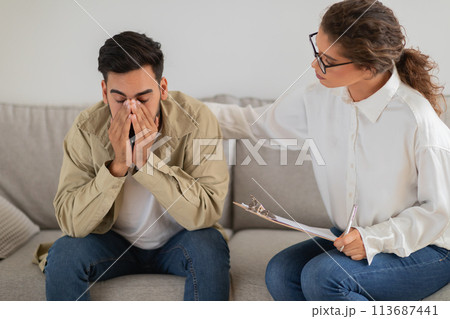 Upset man with hand on face during therapy Upset man with hand on face during therapy 113687441