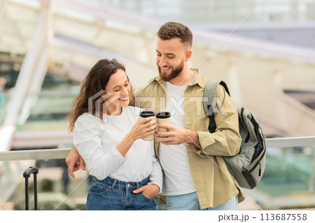 Cheers For Trip. Happy couple clinking cups with takeaway coffee at airport Cheers For Trip. Happy couple clinking cups with takeaway coffee at airport 113687558