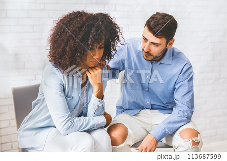 Supportive people comforting depressed black woman at group therapy meeting 113687599