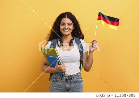 Student holding a German flag and notebooks 113687609