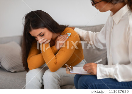 Woman receiving consolation from a lady therapist 113687629
