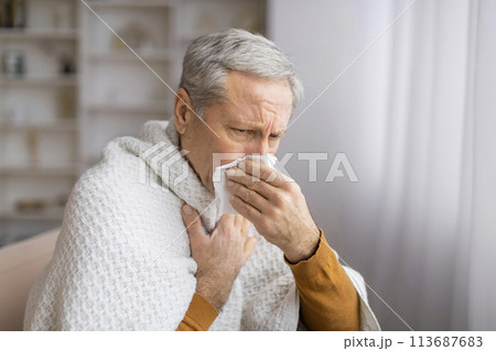 Elderly person reading with a square in front Elderly person reading with a square in front 113687683
