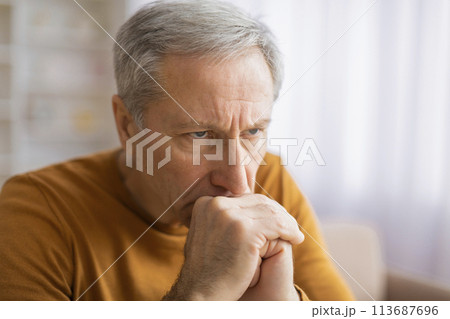 Elderly person with hand on neck feeling pain 113687696