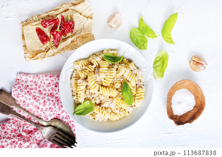 boiled pasta with minced meat and basil 113687838