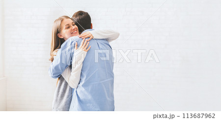 Happy spouses cuddling each other after group meeting with relationship therapist. 113687962