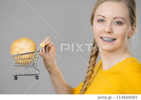 Woman holding shopping cart with bread 113688085