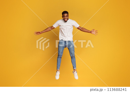 Funny young black man jumping on the air 113688241