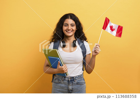 Happy student holding a Canadian flag Happy student holding a Canadian flag 113688358