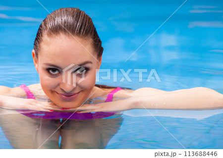 woman enjoying the water in swimming pool 113688446