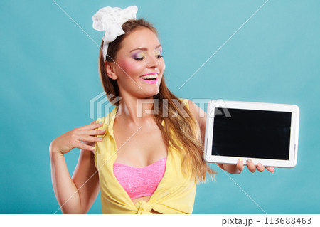 Pin up girl with tablet. Blank screen copyspace. Pin up girl with tablet. Blank screen copyspace. 113688463