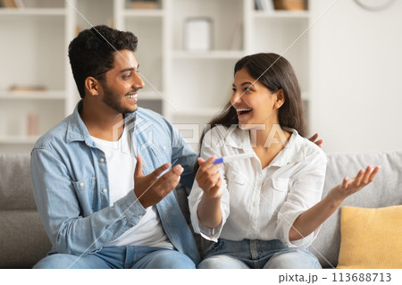 Joyful indian spouses with pregnancy test, excited reaction Joyful indian spouses with pregnancy test, excited reaction 113688713