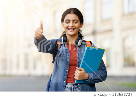 Indian student giving thumbs up on campus Indian student giving thumbs up on campus 113688727