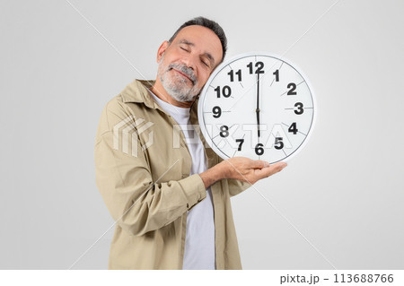 Senior man with clock symbolizing time concept 113688766