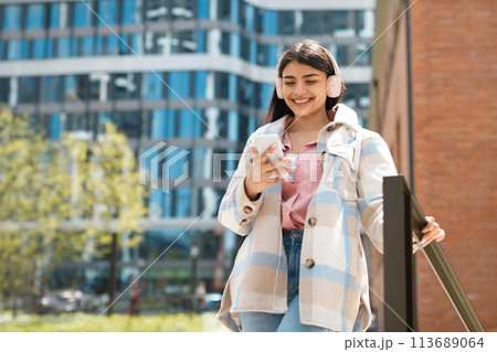 University student with jacket texting on phone 113689064