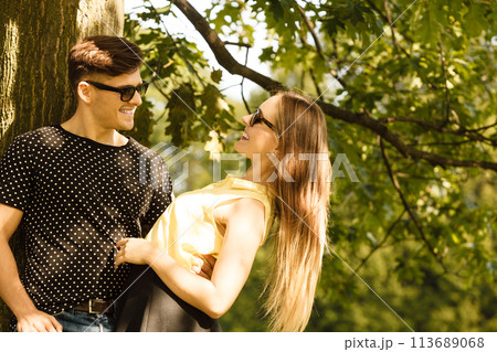 Couple hugging under tree. Couple hugging under tree. 113689068