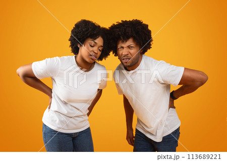 Unhappy millennial african american spouses suffer from back pain 113689221