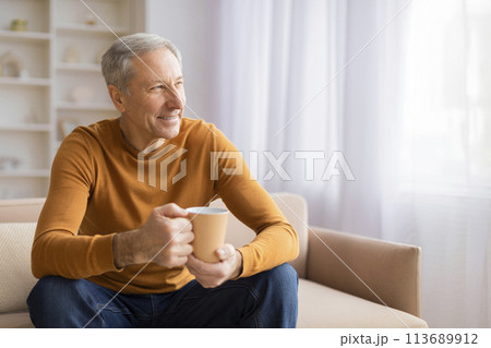 Senior man relaxing with a cup of coffee Senior man relaxing with a cup of coffee 113689912