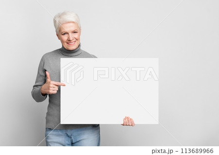Senior woman holding a blank white board Senior woman holding a blank white board 113689966