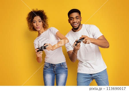 Emotional couple playing video game with joysticks Emotional couple playing video game with joysticks 113690017
