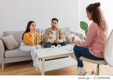 Couple in therapy session with counselor woman 113690400