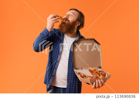 Caucasian redhaired bearded guy enjoys cheat meal with pizza, studio Caucasian redhaired bearded guy enjoys cheat meal with pizza, studio 113690836