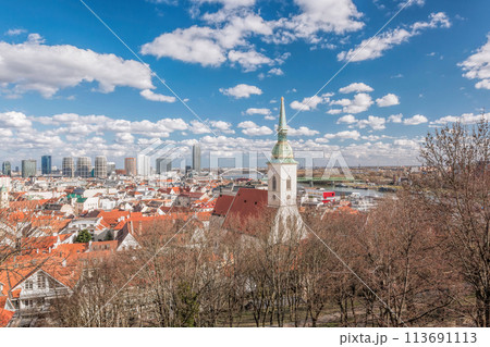 Bratislava cityscape view with old church against modern skyscrapers next to Danube river and old town in Slovakia. 113691113