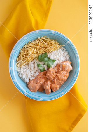 Chicken strogonoff with rice and potato straw on yellow Chicken strogonoff with rice and potato straw on yellow 113691146