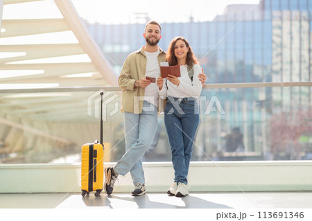 Happy Couple Walking With Suitcase and Passport at Airport Terminal 113691346
