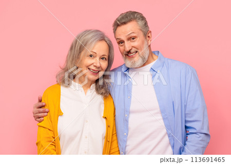 Cheerful senior man and woman in casual sharing embrace, studio Cheerful senior man and woman in casual sharing embrace, studio 113691465