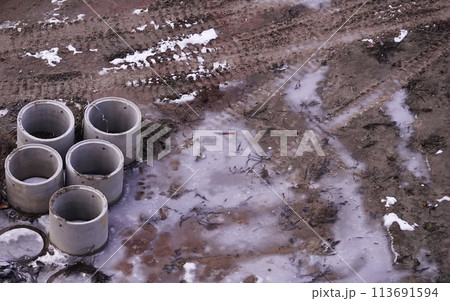 Kiev, Ukraine, October 17, 2018: Workers in the mud of a construction site at the stage of excavation; construction of a supermarket AUCHAN Kiev, Ukraine, October 17, 2018: Workers in the mud of a construction site at the stage of excavation; construction of a supermarket AUCHAN 113691594