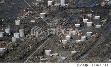 Kiev, Ukraine March 13, 2019: Foundation zero cycle construction, concrete piles at construction site Kiev, Ukraine March 13, 2019: Foundation zero cycle construction, concrete piles at construction site 113691611