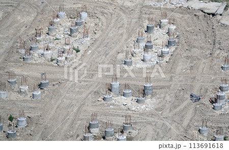 Kiev, Ukraine March 13, 2019: Foundation zero cycle construction, concrete piles at construction site Kiev, Ukraine March 13, 2019: Foundation zero cycle construction, concrete piles at construction site 113691618