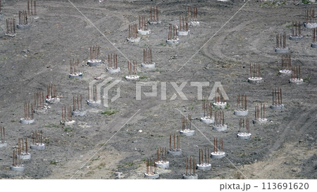 Kiev, Ukraine March 13, 2019: Foundation zero cycle construction, concrete piles at construction site Kiev, Ukraine March 13, 2019: Foundation zero cycle construction, concrete piles at construction site 113691620