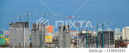 Kyiv, Ukraine April 7, 2022: tower construction cranes on the construction of high-rise buildings Kyiv, Ukraine April 7, 2022: tower construction cranes on the construction of high-rise buildings 113691641