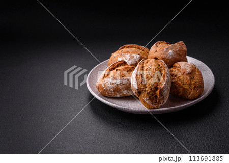 Fresh baked bread buns with salt, spices, seeds and grains Fresh baked bread buns with salt, spices, seeds and grains 113691885
