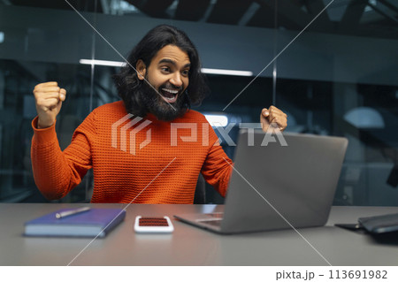 Man excited with computer in office Man excited with computer in office 113691982