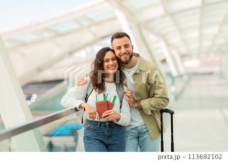 Happy Couple Enjoying Time Together at an Airport Terminal Happy Couple Enjoying Time Together at an Airport Terminal 113692102