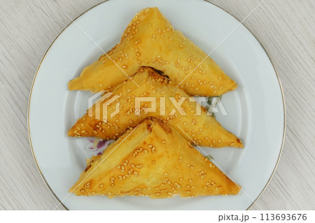 Eastern cuisine. Samosas in a plate on a white background. Homemade food. Fast food. Top view. 113693676