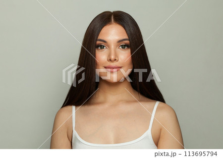 Perfect young woman brunette with long healthy hair and fresh silky skin posing Perfect young woman brunette with long healthy hair and fresh silky skin posing 113695794