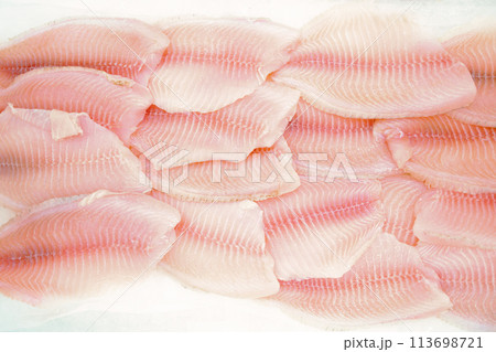 Butchered fish fillets are laid out (flat lay)  on ice on the  stalls (counter) of the grocery store. High detail and sharpness - ability to crop. 113698721