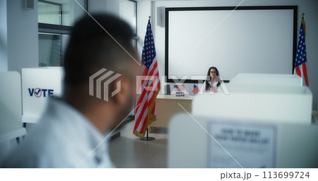 Close up of African American male voter in voting booth Close up of African American male voter in voting booth 113699724