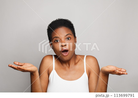 Lovely happy young woman holding empty blank hand palm. Advertising, product placement 113699791