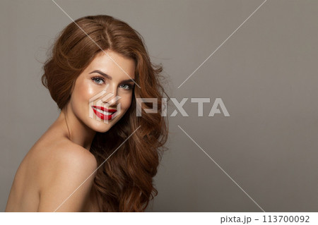 Elegance fashionable redhead woman with long wavy hair and make-up. Studio headshot portrait Elegance fashionable redhead woman with long wavy hair and make-up. Studio headshot portrait 113700092