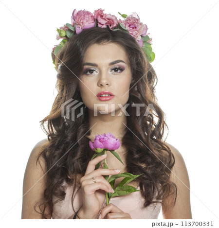 Stylish female model in floral summer wreath on her hair. Young woman with clean skin Stylish female model in floral summer wreath on her hair. Young woman with clean skin 113700331