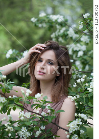 Cheerful lady female model in spring leaves background 113700752