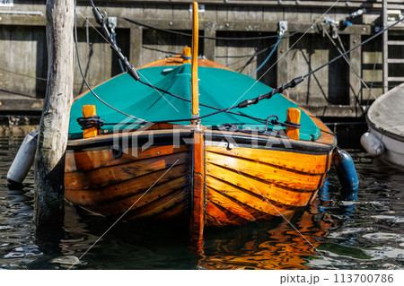 Close-up detail view of Christianshavn registration mooring port name on boat board in Copenhagen canal marina embankment   on sunny day. Christianshavn harbor neighborhood district lifestyle 113700786