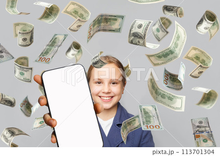 Cute little girl having fun with empty white smartphone display and falling US Dollar money 113701304