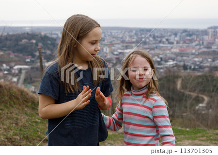Cute little girls playing outdoors 113701305