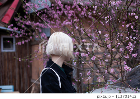 Healthy young woman in spring against blossom tree flowers background 113701412